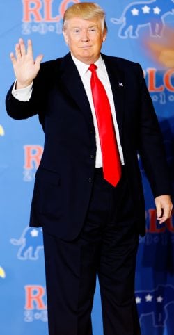 Donald Trump holding his palm up. The meaning of hand signs varies by country.