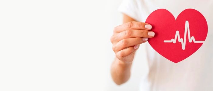 Hand holding a heart-shaped cutout to represent the Korean slang term