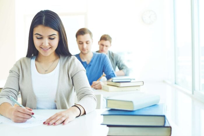 Row of students taking an english language test for citizenship in the UK. 