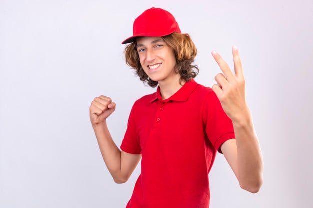 Male teenager foing the V hand sign with the index and middle fingers up and the palm facing in 