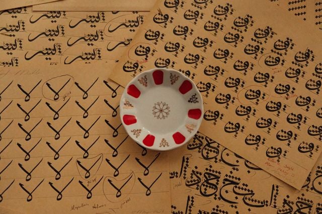 Arabic calligraphy practice sheets showing different letter shapes, strokes, and writing styles.