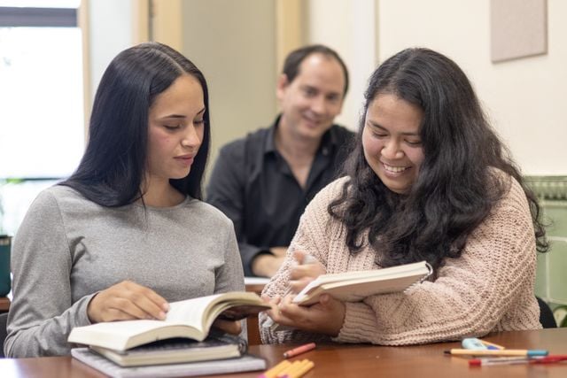 Portuguese learners studying together in class.