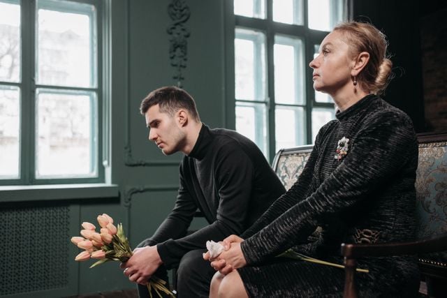 1. Young man holding flowers beside an older woman, representing apology and reconciliation in French culture.
