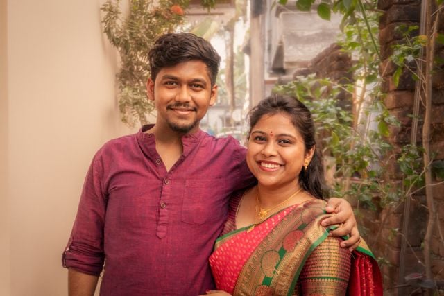 Telugu-speaking couple wearing traditional Indian clothing and smiling together.