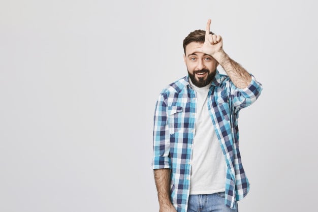 Man doing the L hand sign over his forehead